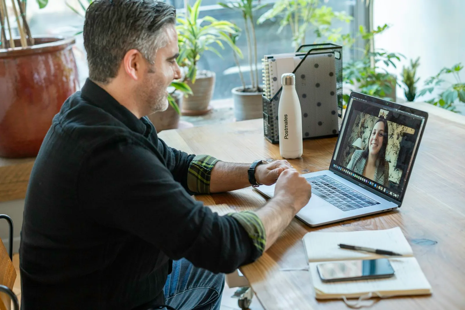 Employee on a video call working remotely from a laptop