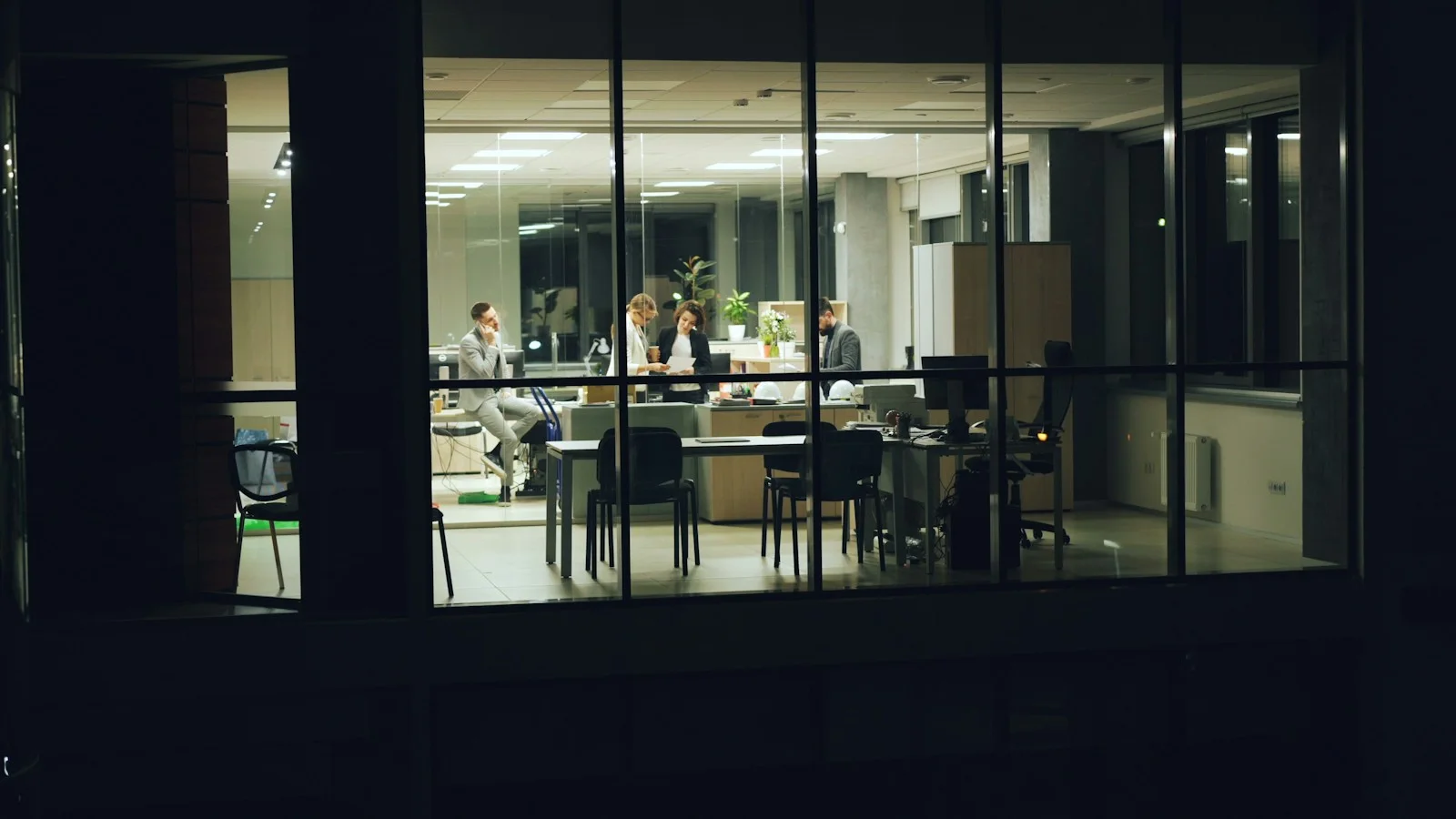 An office lit up at night, its team still at work